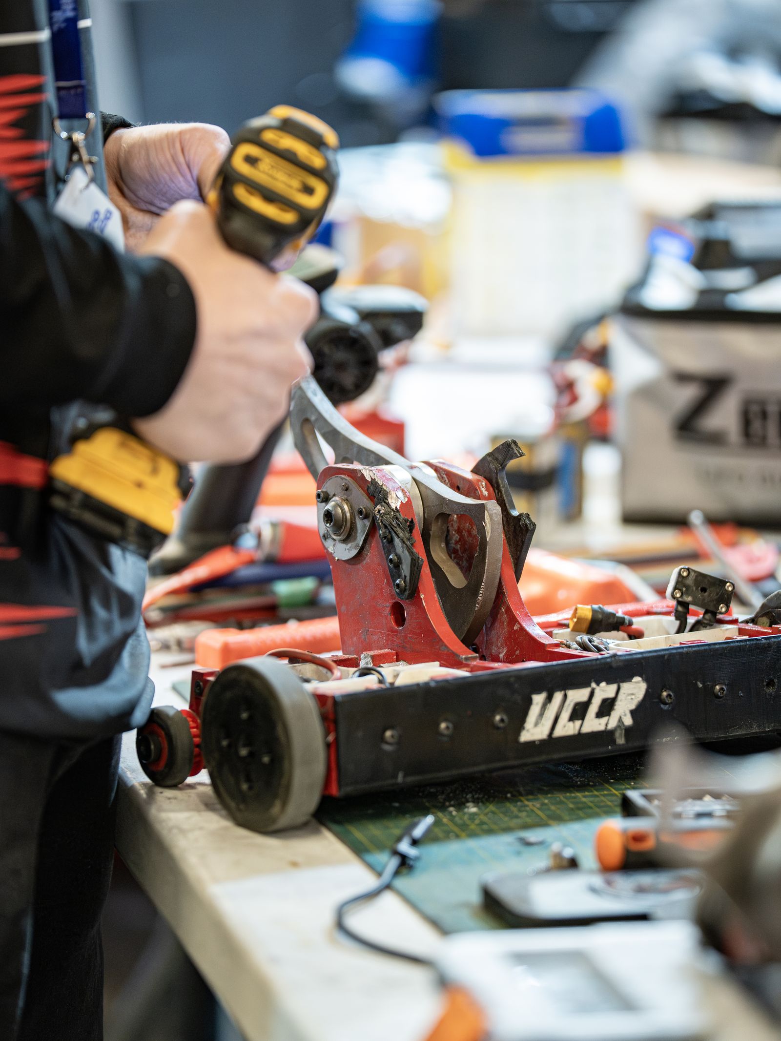A UCCR member working on a robot in the shop